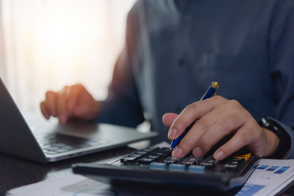 Accountant working hands using calculator