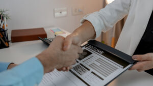 HR manager shakes hands with a new employee