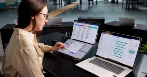Woman In Office Uses Payroll Software